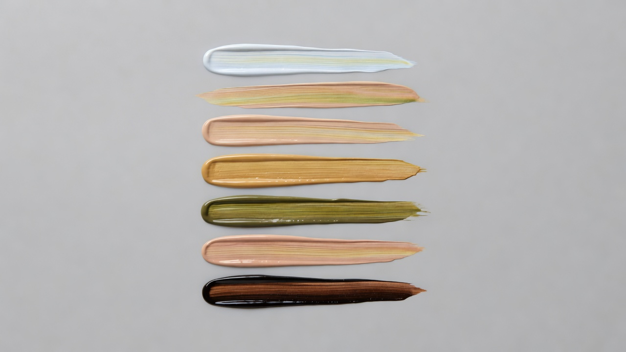 Liquid foundation swatches showing different undertones under bright studio lighting